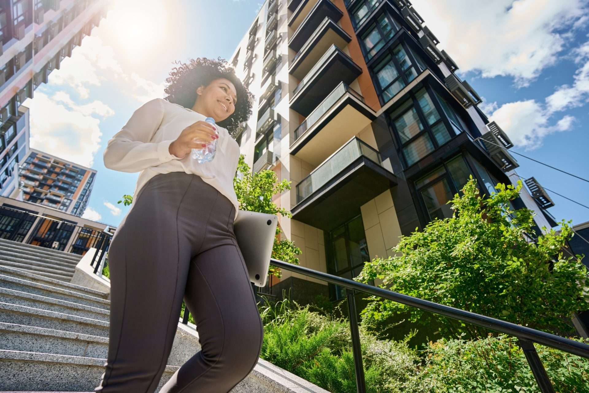 Diverse group of small investors using smartphones to buy real estate tokens via blockchain platforms