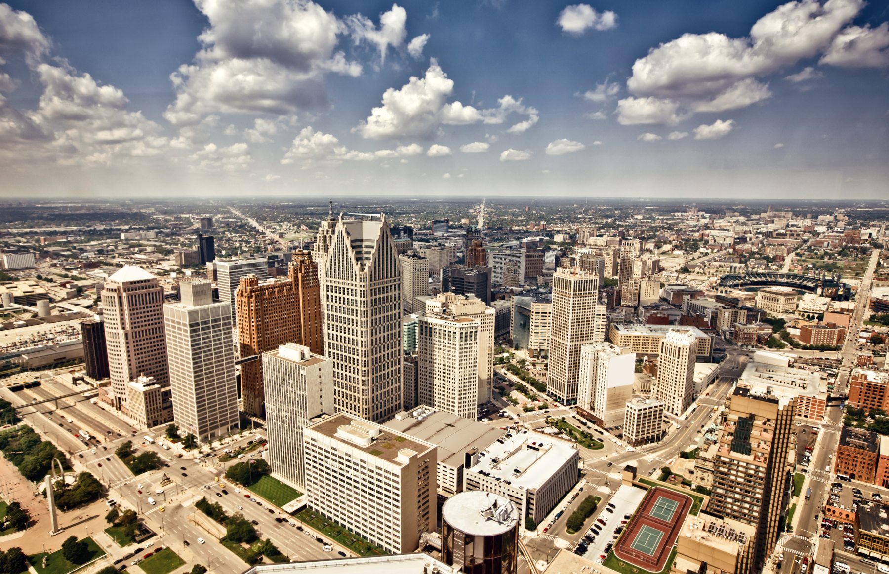Vibrant aerial drone view of Detroit neighborhood with colorful rental properties tokenized by RealT and Lofty AI for 8-12% yields